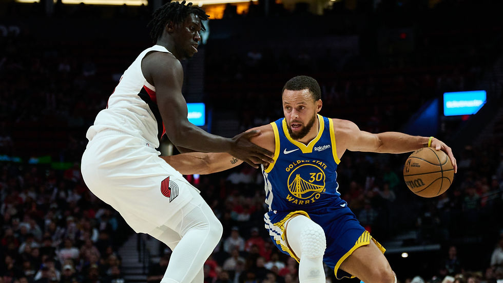 Golden State’s Stephen Curry drives past Portland defenders during the Warriors’ 118–111 preseason win, as teammates rally after Jonathan Kuminga’s ejection.