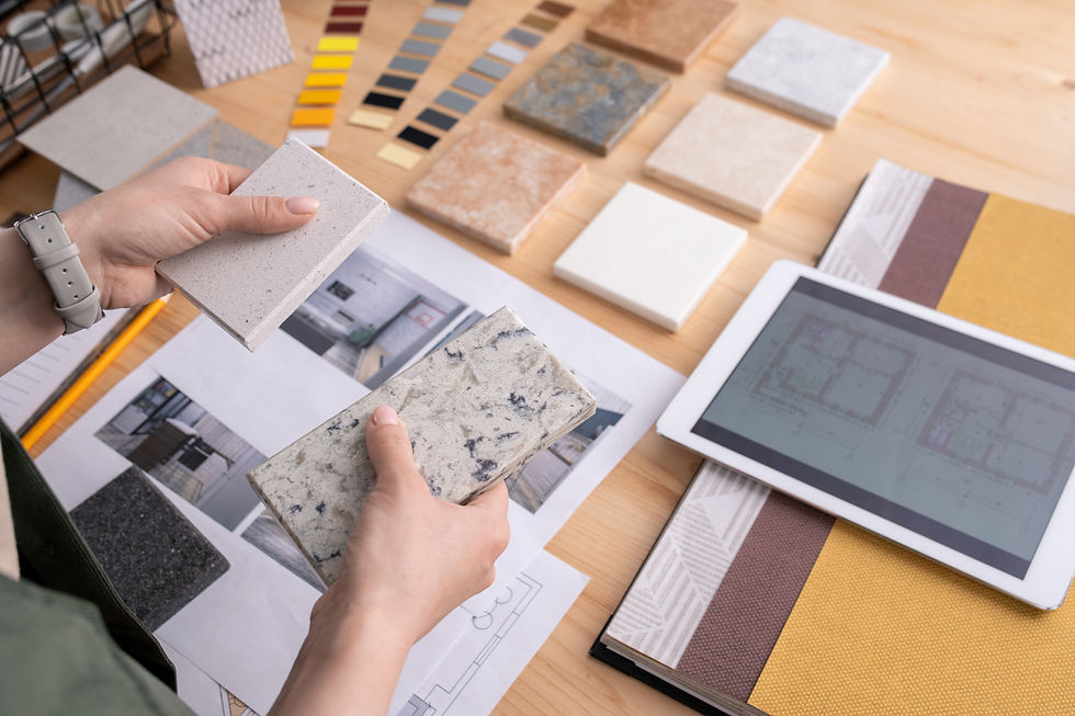 Close-up view of person reviewing kitchen materials and layouts on site
