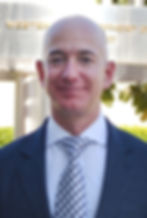 Jeff Bezos in blue suit and tie smiling
