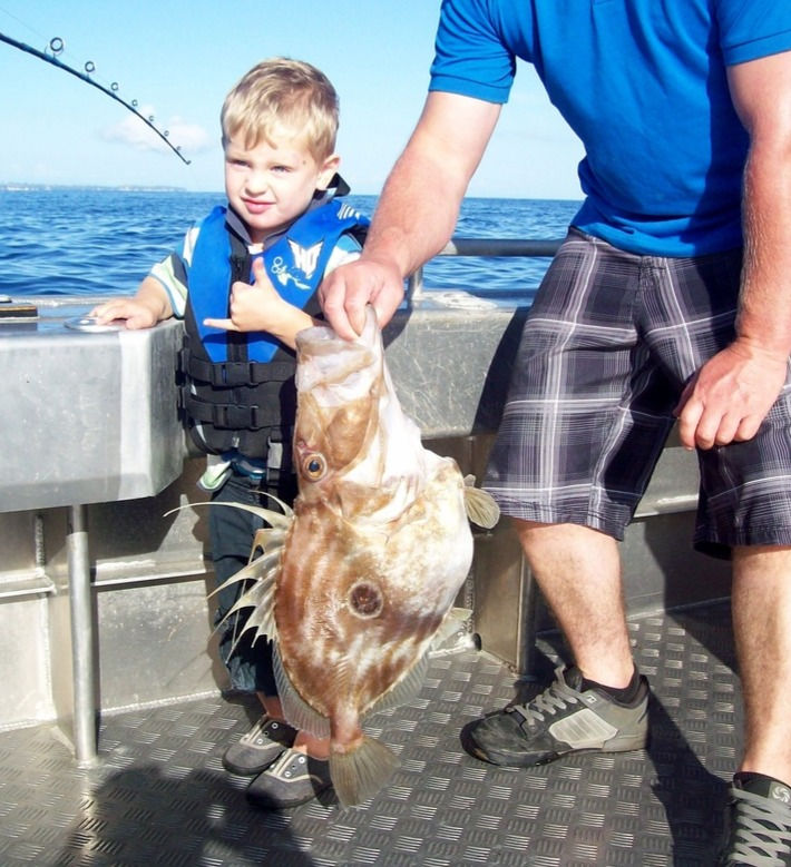 Young boy charter fishing