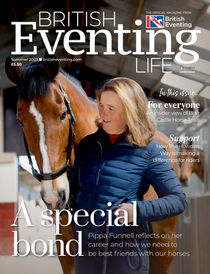 Equestrian sportswoman Pippa Funnell MBE, pictured in her stables holding one of her horses with it's head over her shoulder.