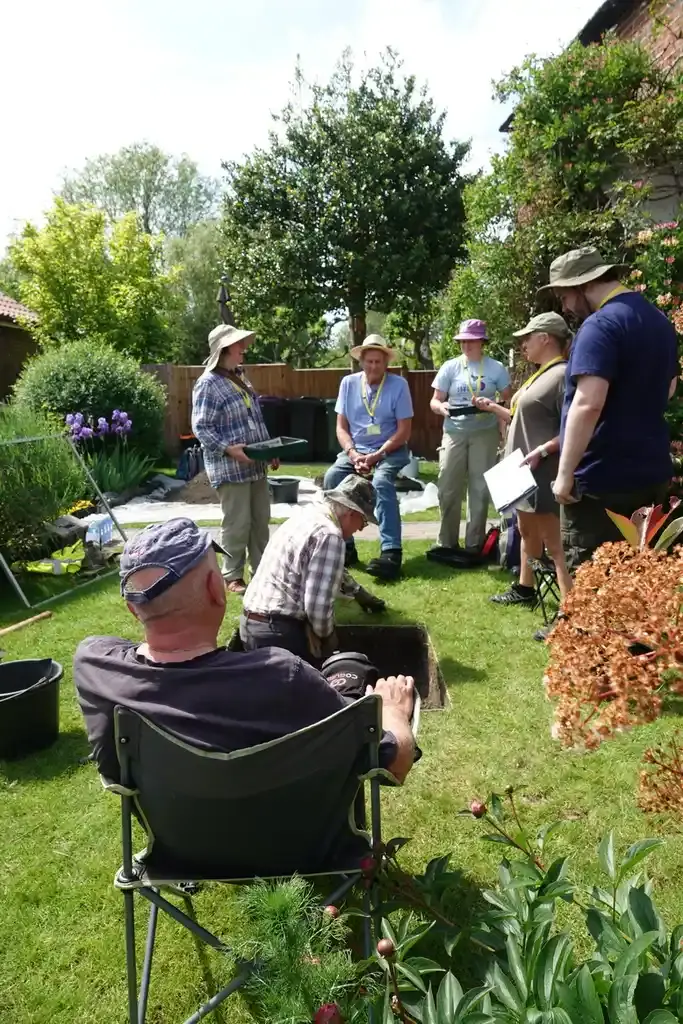 Avril, David, Jane and Joe look on as Bob does all the work in the trench and Andy relaxes in a deckchair.