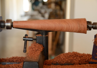 Wood lathe shaping a piece of wood