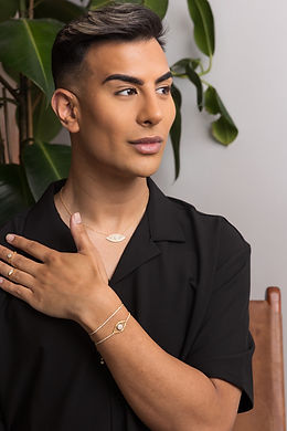 male model displaying gold wrist and neckwear
