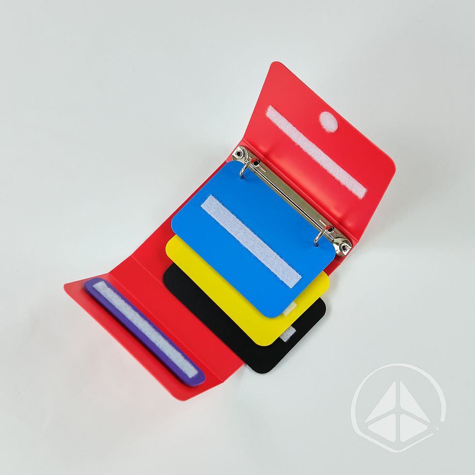 Thumbnail: Mini red PECS communication book with blue, yellow, and black removable insert pages and a purple sentence strip