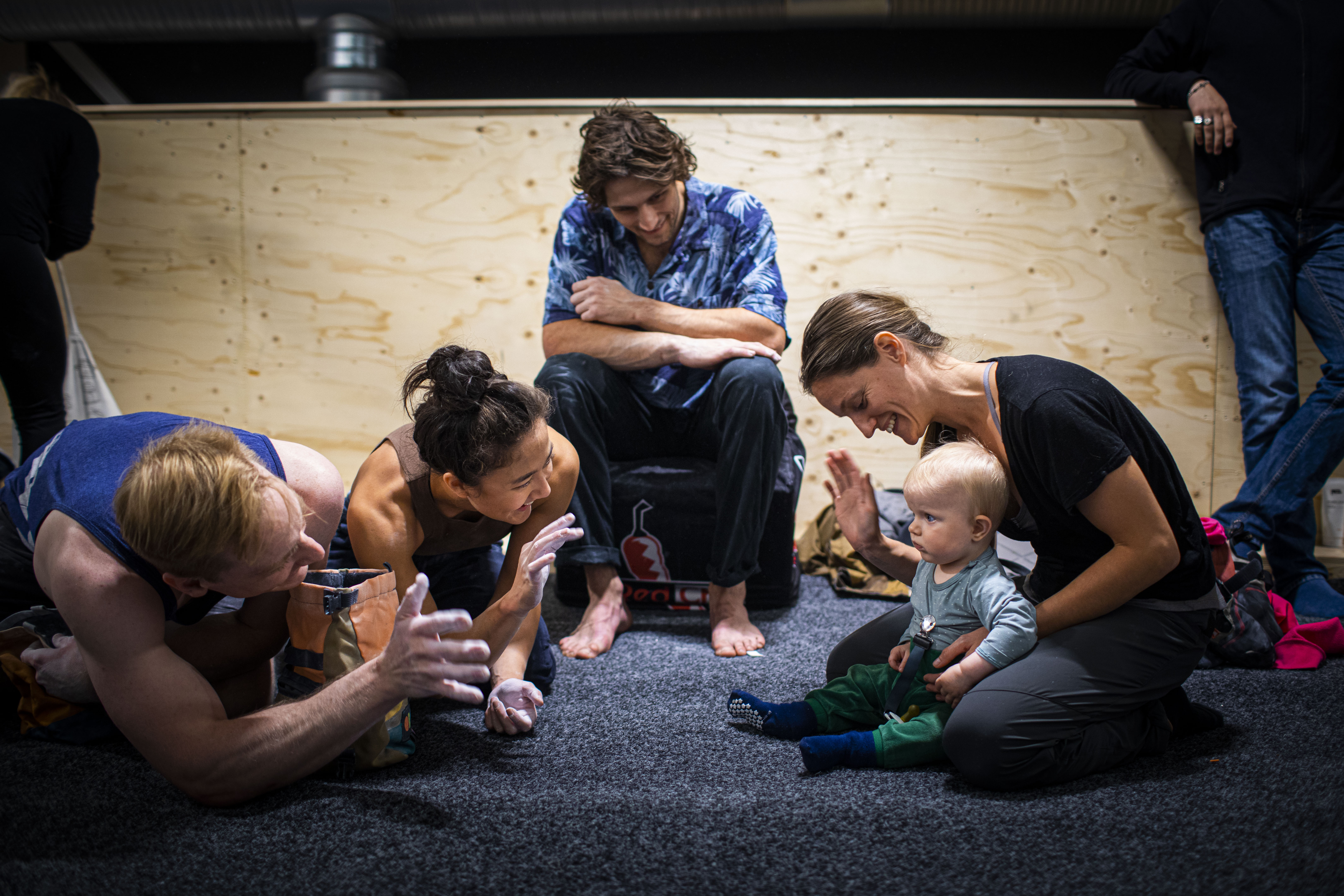 A baby and happy adults at BLX Bouldering Club