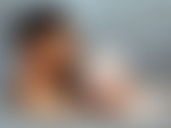 an interracial couple sharing an intimate in the bathtub