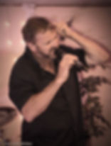 Kelvin Rouse, the passionate founder of Rouse Roofing, enjoying his personal hobby of singing in a band, highlighting the div