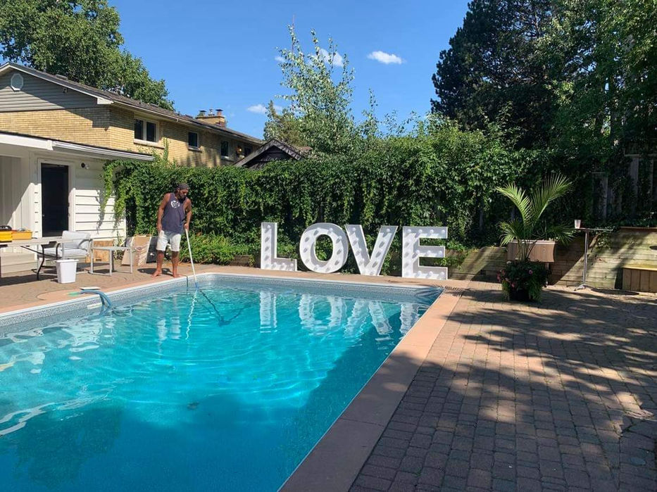 Love marquee letters by a pool