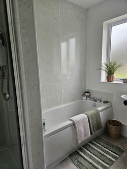 the bathroom, containing a bath and separate shower