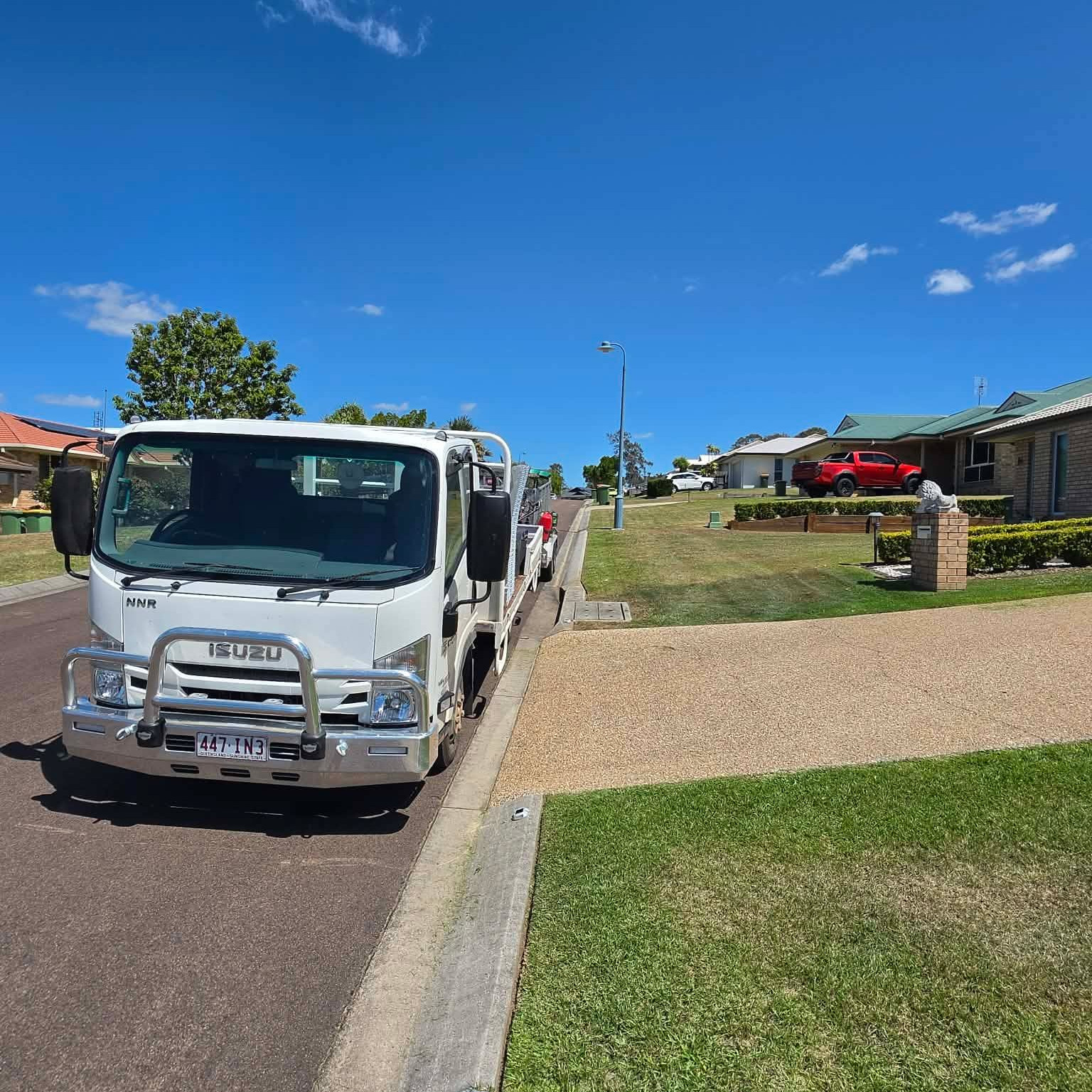 Mowing To Yous professional crew on a job site with their truck and trailer setup.