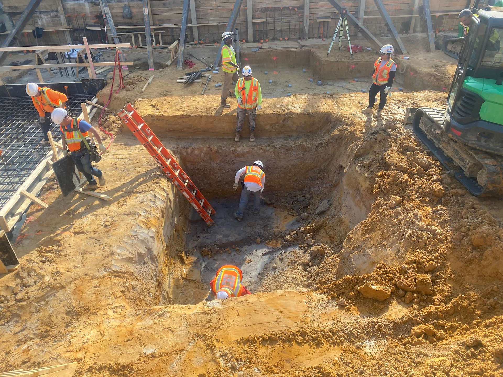 201 K Street NE - construction of foundation, workers digging pit