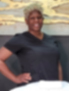 An esthetician smiling confidently, ready to assist clients in achieving their skincare goals with personalized treatments an
