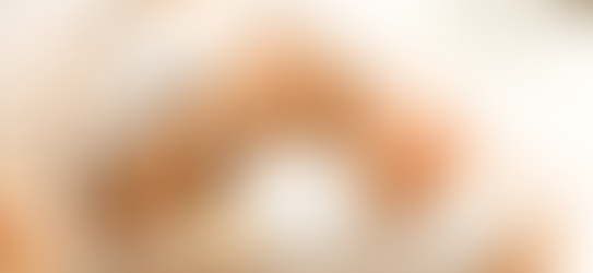 Woman receiving a facial mask with a brush, eyes closed, relaxed. Logo "Club Aesthetics" in the corner, spa setting, soft lighting.