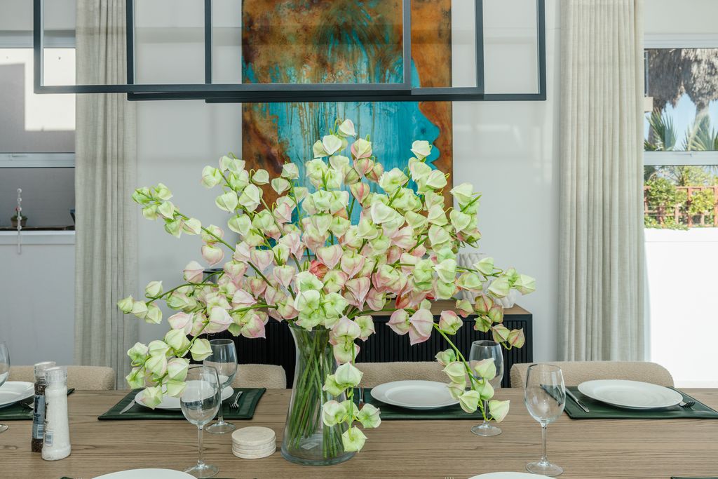 Dining table set with green and white floral centerpiece
