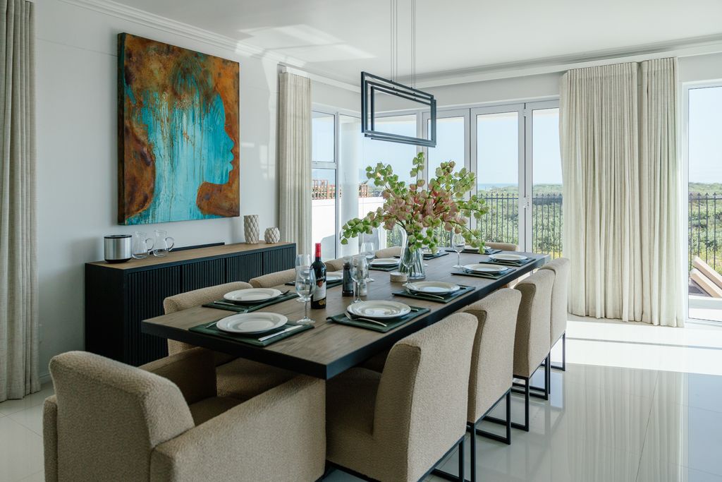 Modern dining room with large table and blue abstract art