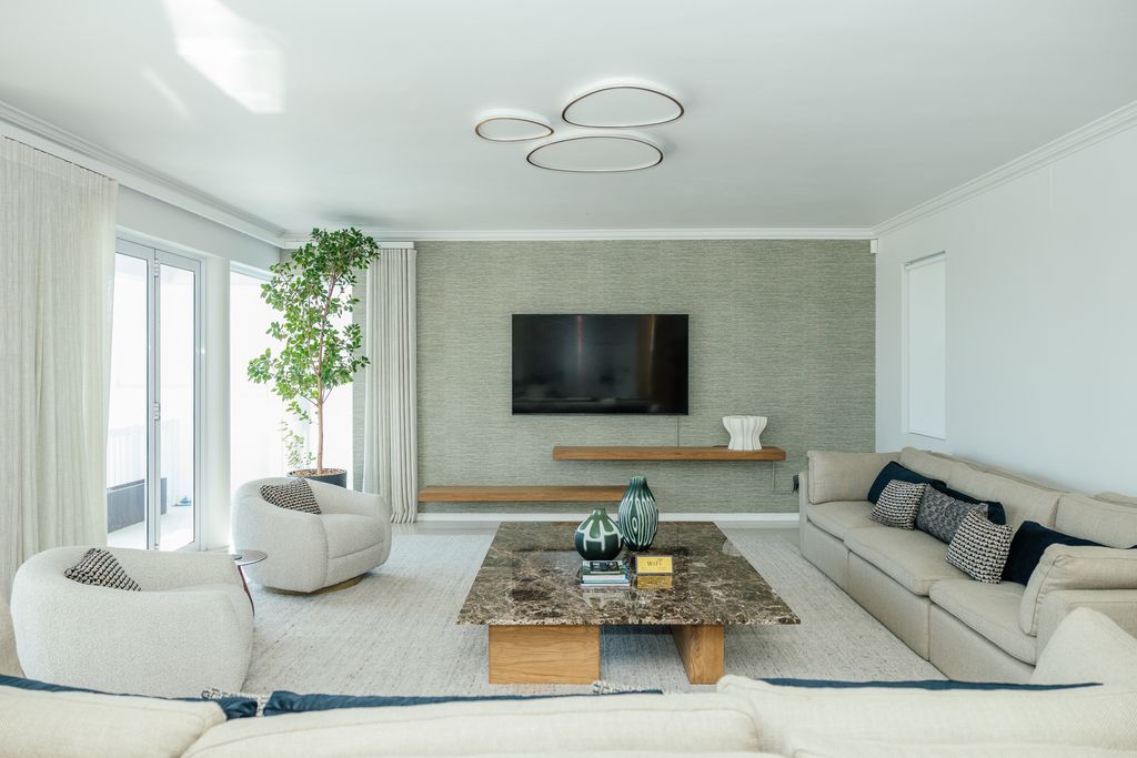 Modern living room with marble coffee table and wall-mounted TV