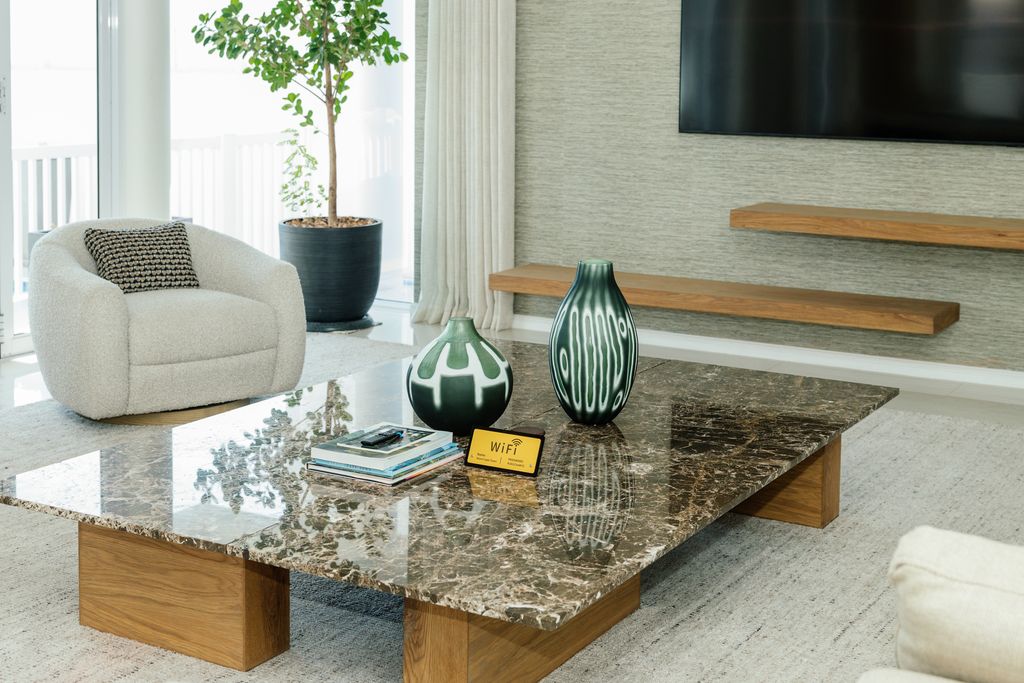 Modern living room marble coffee table with green vases.
