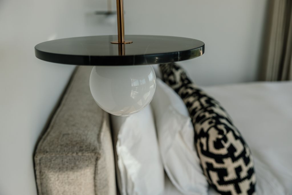 Modern bedside pendant lamp with marble disc and globe light