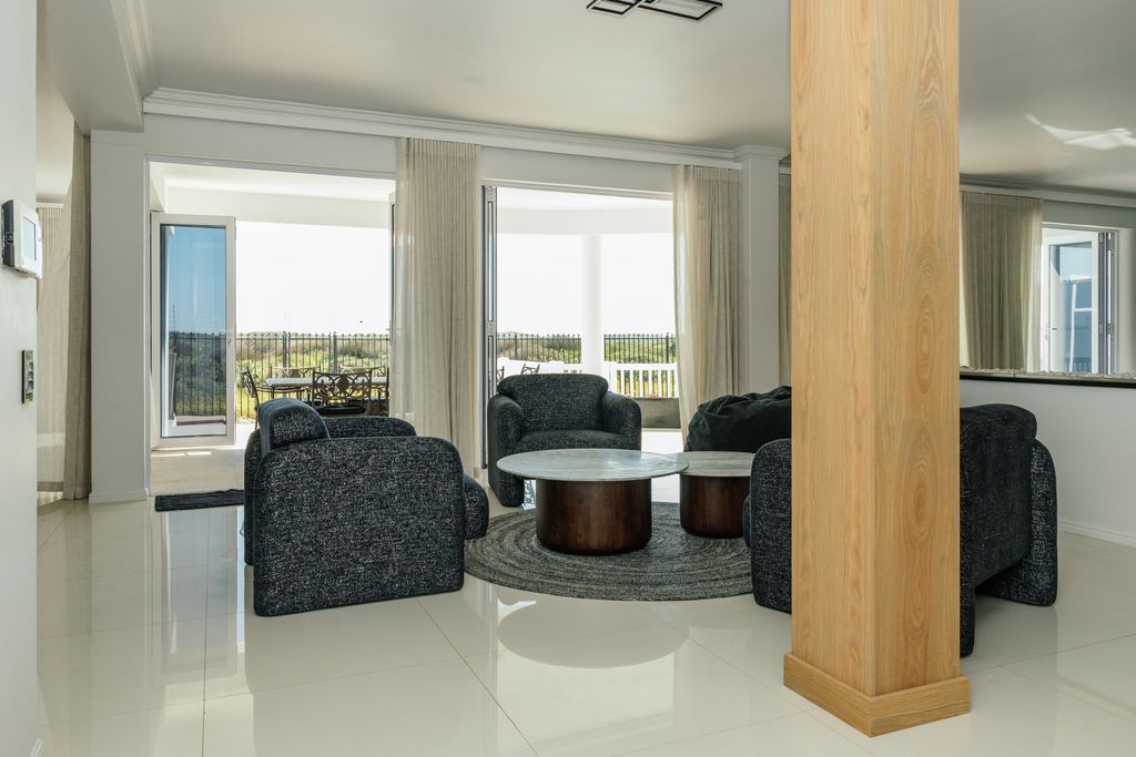 Modern living room with dark armchairs and patio view