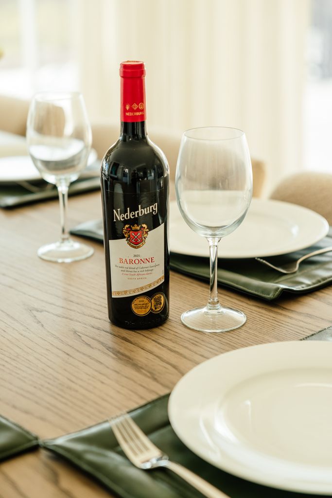 Nederburg Baronne red wine bottle on a set dining table