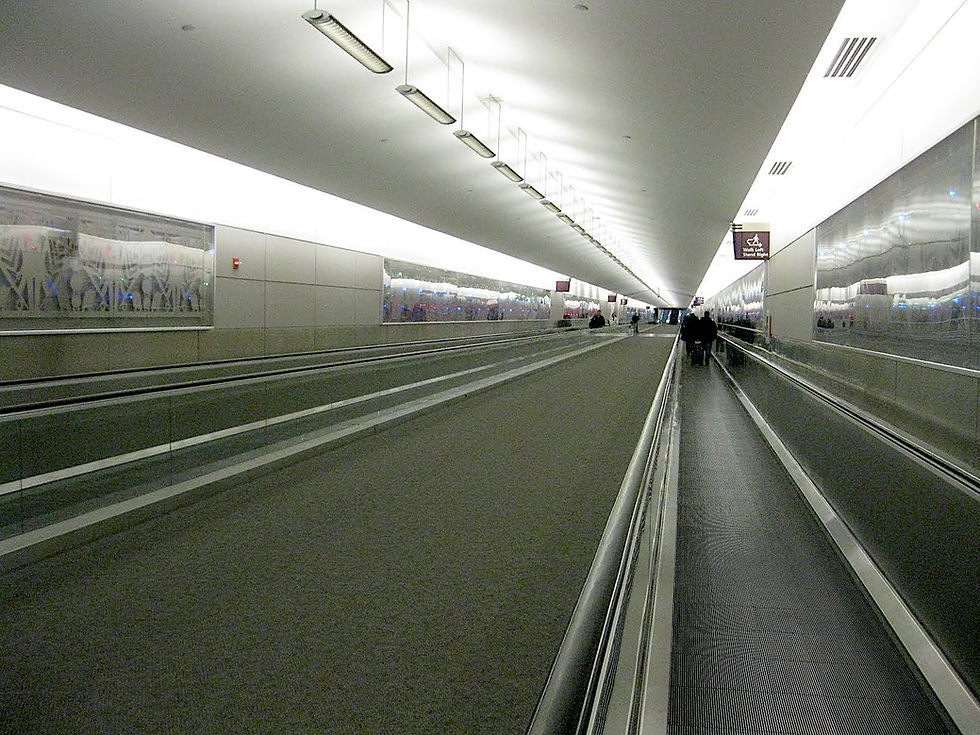 The tunnel connecting Concourses C and D with the metal frieze, Time Flies, by Mark Howard, adorning the walls, taken on February 27, 2012. (airlineterminals.blogspot.com) 