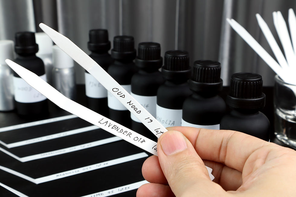 blotter papers are in a glass with background essential oil and frangrance oil bottle for 