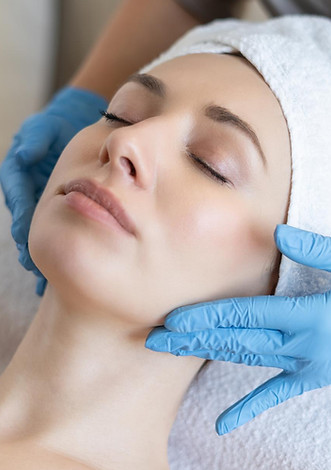 young-beautiful-girl-lies-table-beautician-receives-procedures-light-massage-hands-blue-gl
