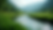 Close-up view of a tranquil river flowing through a lush green valley