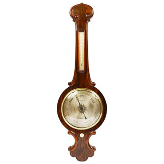 Old fashioned wooden barometer. Consists of a dial on the bottom and a tube on top.