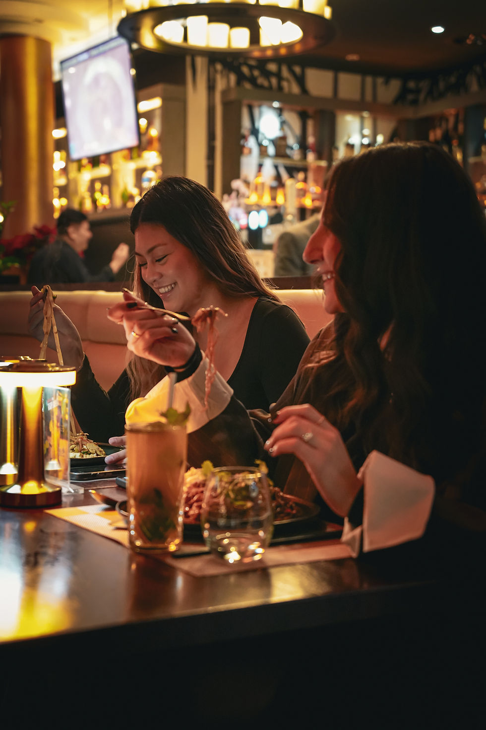 Deux femmes rient au restaurant.