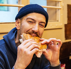 Man eating a sandwich - Art and food Tours Bologna
