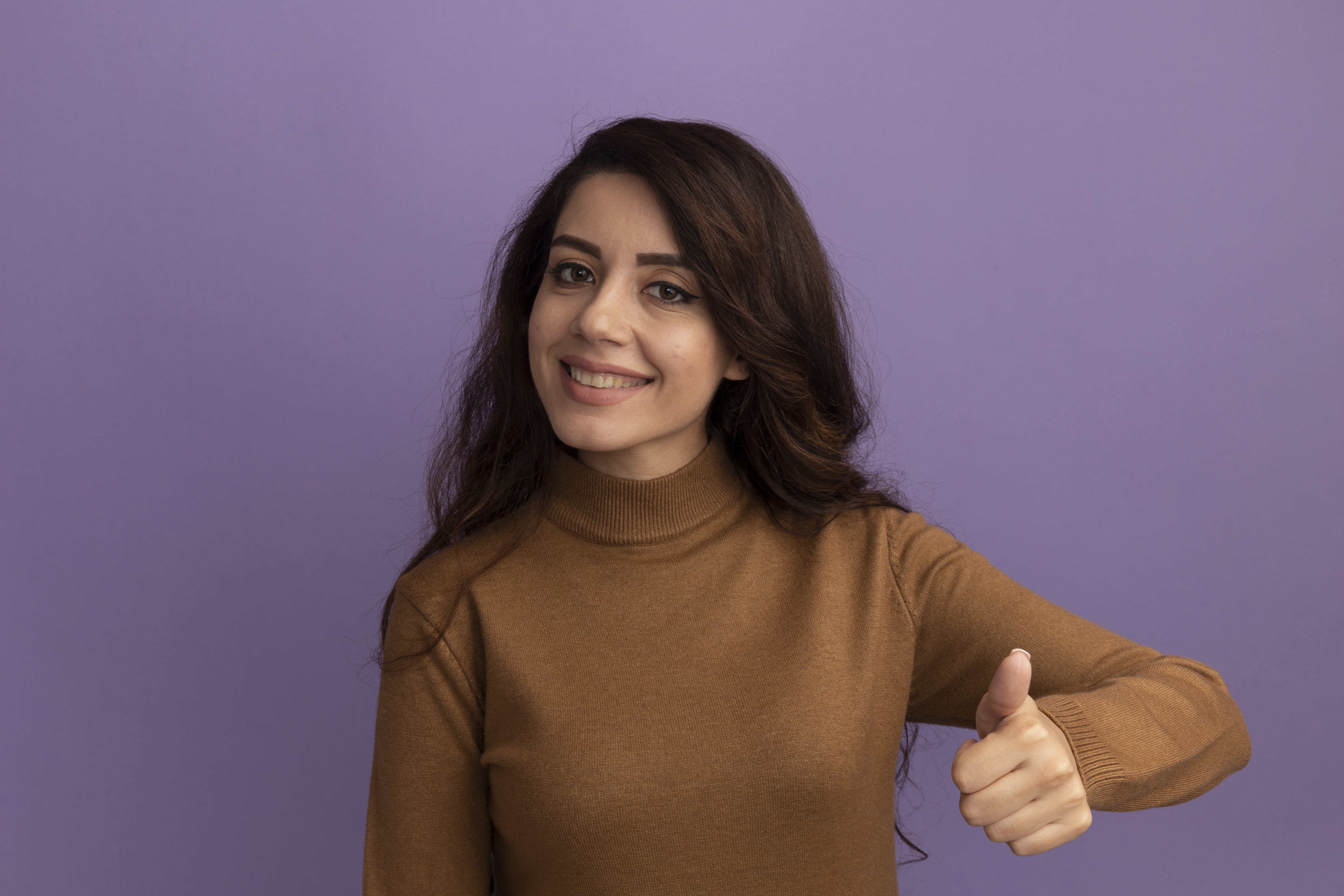 smiling-young-beautiful-girl-wearing-brown-turtleneck-sweater-showing-thumb-up-isolated-pu