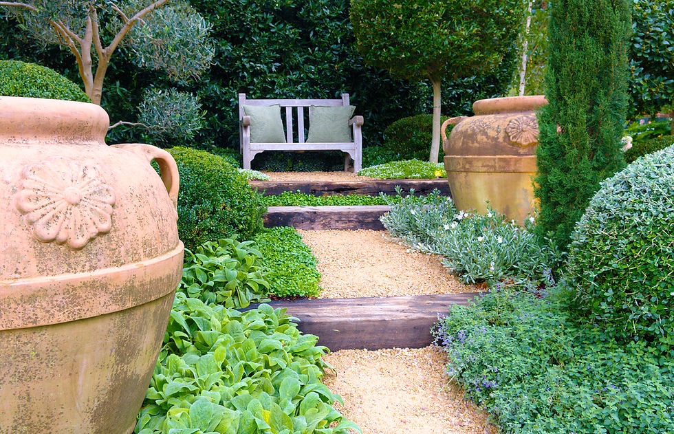 Bench and large terracotta pots in show garden