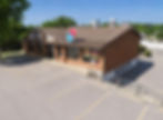 Office space for lease in a brick building with a For Lease sign