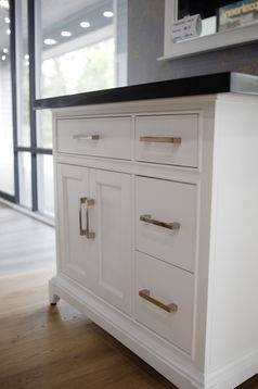 Photo of a white vanity cabinet with quartz countertop