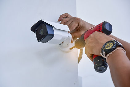 Technician installing CCTV camera for se