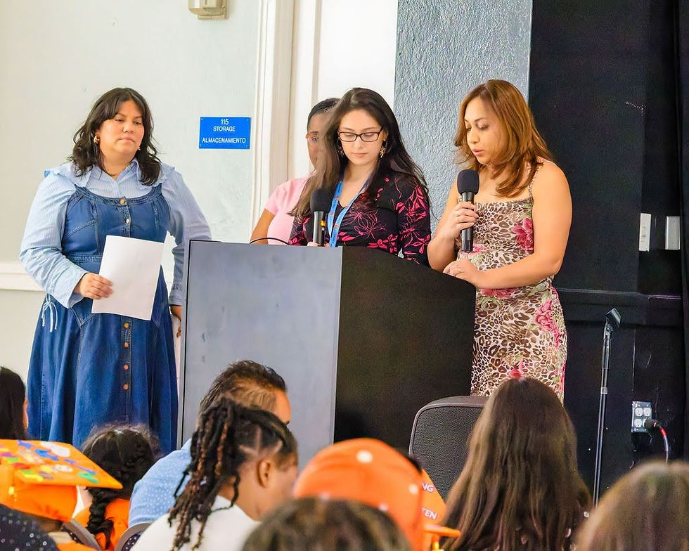 Jenny speaks on stage at the Book Babies graduation.