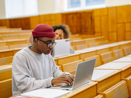 University student using a laptop in a lecture hall — ART evidence Nepali student visa