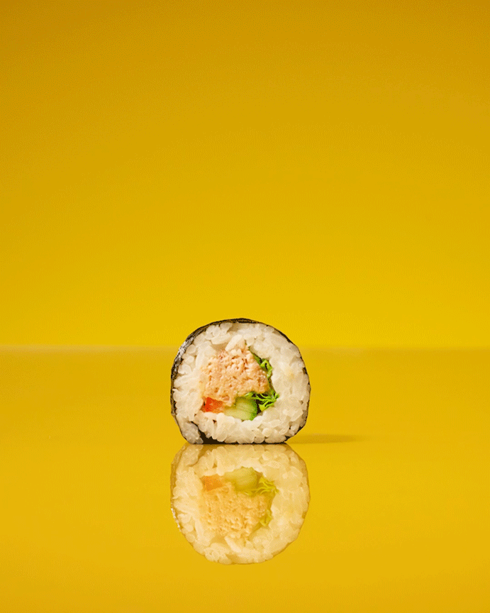St Pierres Sushi spinning into multiple sushi pieces on a yellow background