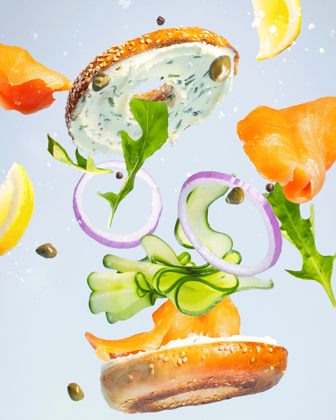 regal salmon bagel floating with ingredients then falling down to land on a plate