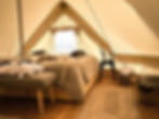 The inviting interior of a Nomad Greenland tent in Saqqaq, featuring plush amenities for a private, luxurious retreat