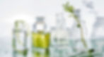 Juvenex Skincare ingredient visuals — clean lab-style imagery of serums, acids, and botanical extracts in glass containers.