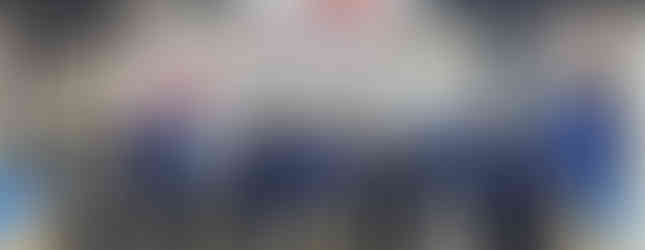 Group of people posing in front of Yash Highvoltage Ltd. booth at exhibition