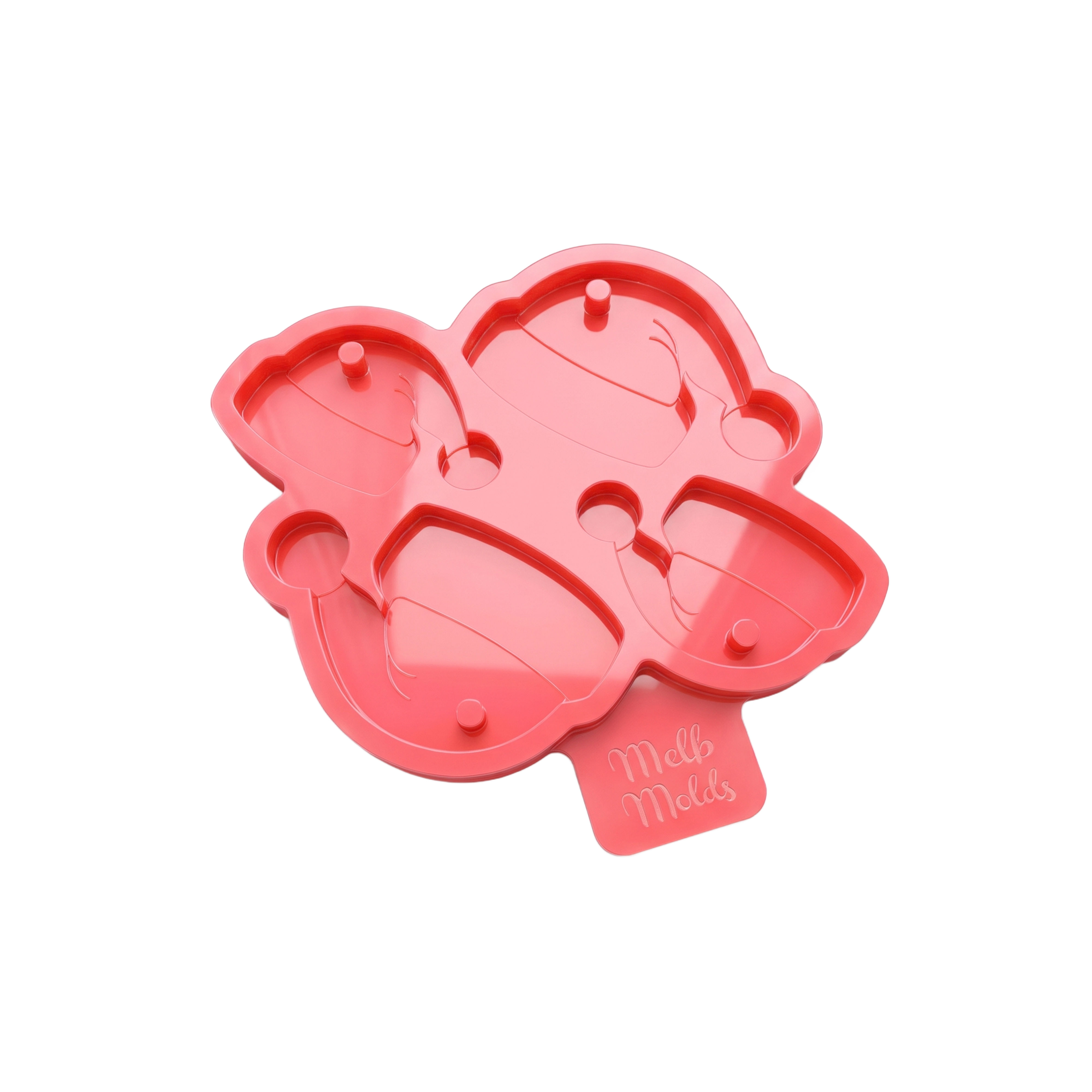 Pink silicone mold with four Santa hat tag cavities in two sizes and hanging-hole pins, by MelbMolds.