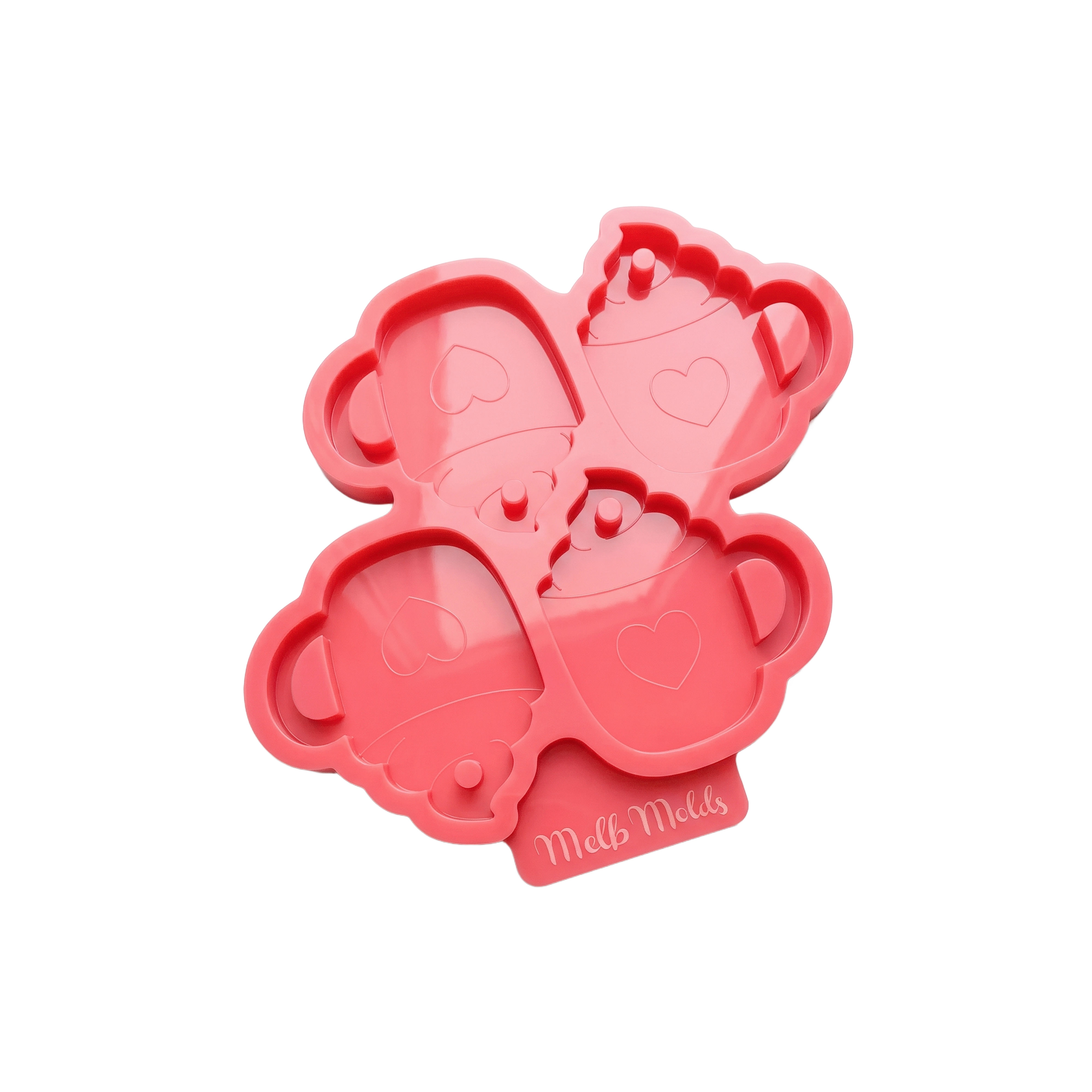 Pink silicone mold with four mug cavities featuring hearts, whipped topping details and hanging-hole pins, by MelbMolds.