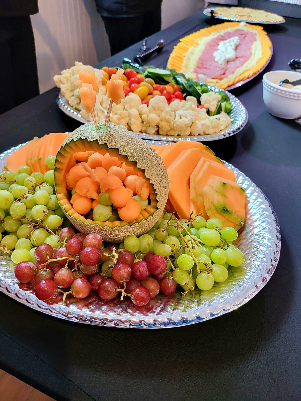 Fresh fruit display – carved melon, grapes and cantaloupe