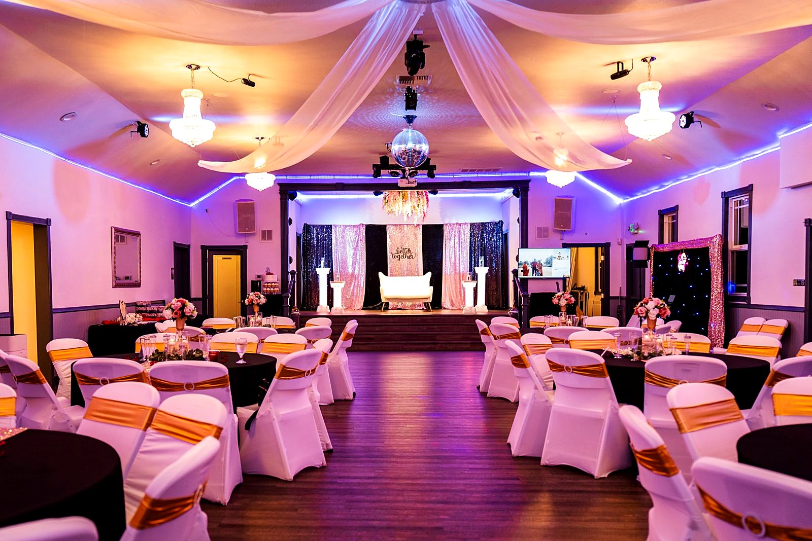Banquet set-up in the main hall with draped ceiling and chandeliers