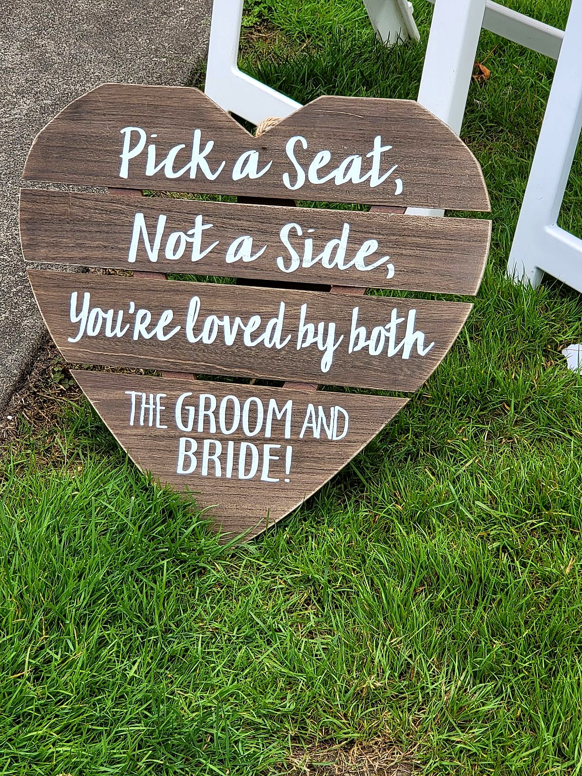 Wooden heart sign by the aisle: "Pick a seat, not a side"