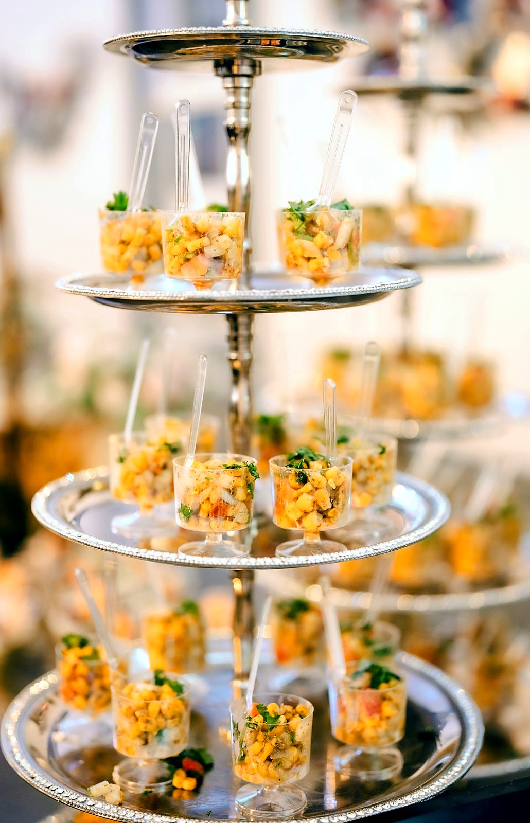 Corn chaat cups on a tall silver tiered stand